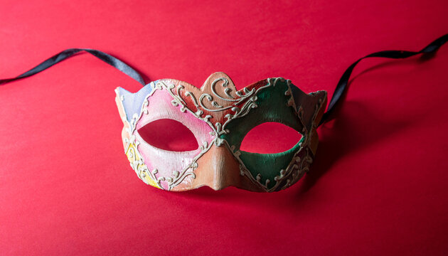Carnival Venetian colorful mask on red color background, disguise, masquerade