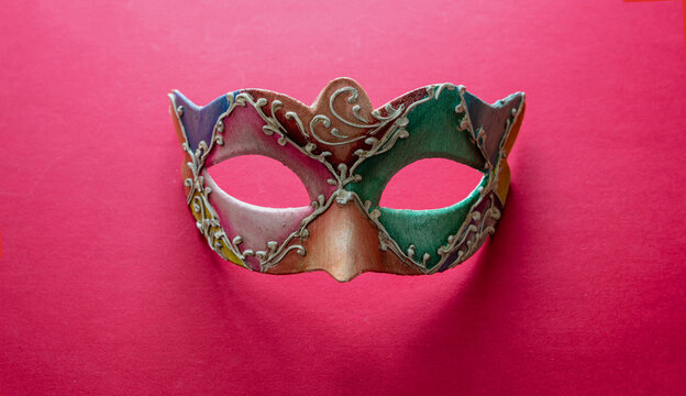 Carnival Venetian colorful mask on red color background, disguise, masquerade