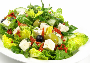 Mixed green Salad with Feta Cheese and dried Tomatoes isolated on white Background