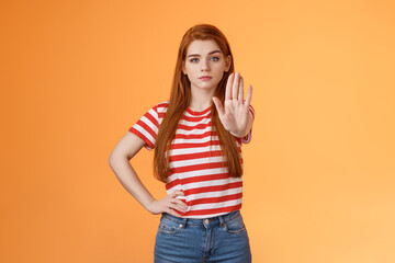 Serious-looking confident brave redhead girl oppose haters, fighting for freedom, prohibit illegal...