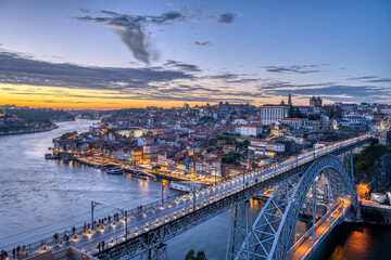 Fototapeta na wymiar View of Porto with the famous iron bridge and the river Douro after sunset