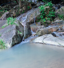 Naklejka na ściany i meble Patong waterfall water gently flowing down the rocks Phuket Thailand Asia