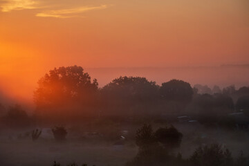 Obraz na płótnie Canvas Spring Field Meadow Road Under Sunset Sunbeams At Dawn Or Sunrise