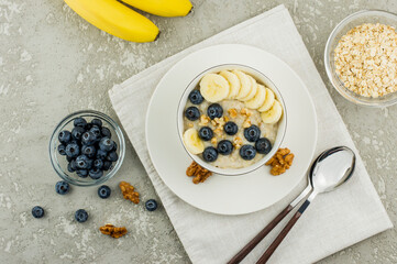 oatmeal with banana, blueberries and walnuts for a healthy breakfast. top view.