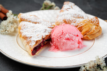 Classic shtrudel dessert with ice cream on white plate