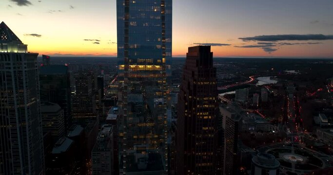 Aerial establishing shot of office building highrise skyscraper. Cityscape at evening dusk sunset. Beautiful light.