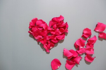 Heart made of Rose petals on gray background. Valentine's day, Mother's day, Women's day concept background.