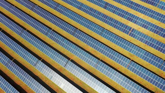 Photovoltaic solar panels farm. Green energy generation. Solar panels field at countryside. Cleaning energy for control of climate change. Environment emissions reduction. 