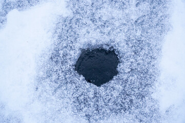 Ice hole in the ice for winter fishing