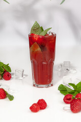 Basil and berry lemonade with fresh raspberries and strawberries with ice