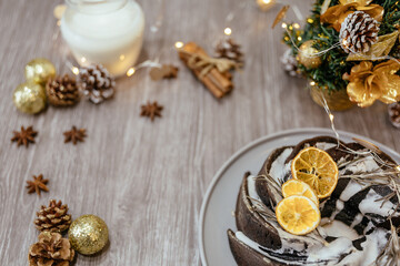 Obraz na płótnie Canvas Christmas fruit cake on wooden table with festive decorations