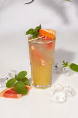 Refreshing cocktail on apple syrup with grapefruit, ice and fresh mint