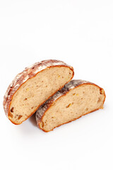 Round wheat bread with cheese inside cut in half on white background