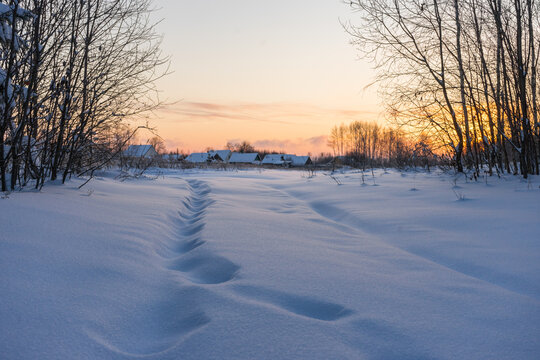 The road to the village covered with snow