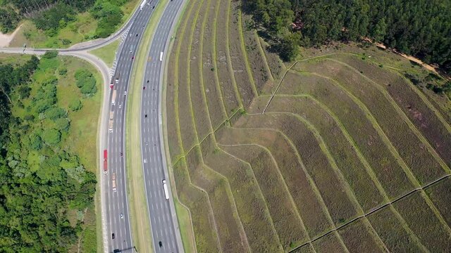Aerial landscape of Bandeirantes highway road at countryside of Sao Paulo state Brazil. Landmark highway road between mountains. Rural landscape. Traffic at road. Brazilian freeway road.