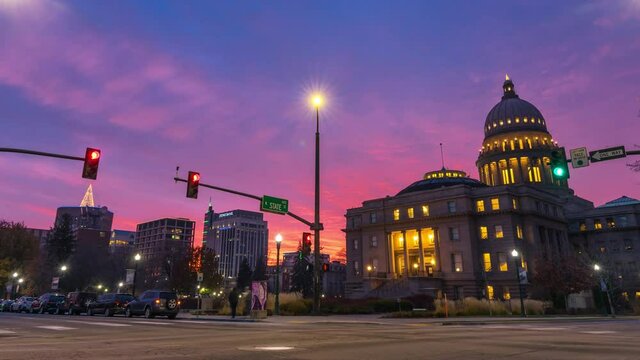 Unbelievable sunset in Downtown Boise Idaho, overlooking the Idaho State Capitol Building with traffic passing by. Taken in December 2021 with Christmas tree light up on one of the buildings.
