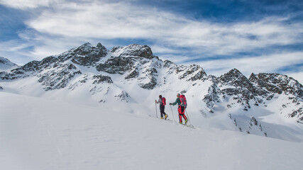Fototapeta na wymiar Couple of friends during a ski mountaineering excursion