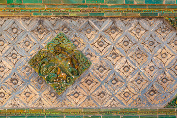 Detail of decoration on a stone wall in the ancient Kumbum monastery for background, Qinghai province, China