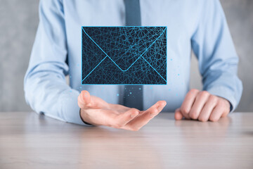 Businessman hand holding letter icon,email icons.Contact us by newsletter email and protect your personal information from spam mail.Customer service call center contact us.Email marketing newsletter.