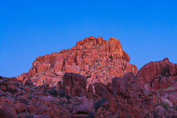 Bare eroded rocks and hills in the Tiras mountains, Namibia, in the blue hour after sunset
