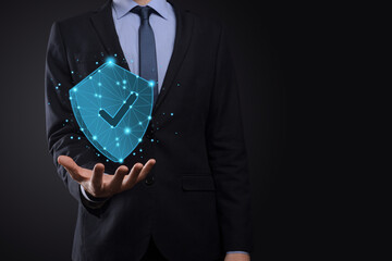 Businessman hold low poly polygon shield with a tick icon.Secure Access System Concept.Business...