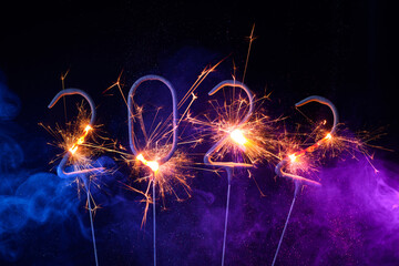 2022 Happy new year greeting card with with sparklers shiny glitter and colorful smoke