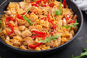 Heart-shaped pasta  in tomato sauce with chicken and sweet pepper with arugula. Background, texture