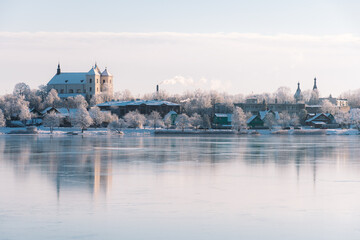 Fototapeta na wymiar Wonderful winter view of Trakai, Vilnius, Lithuania, Eastern Europe, located between beautiful lakes and nature with frozen lake and snow, postcard