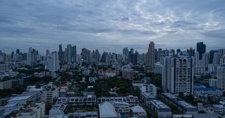 Naklejka na ściany i meble Aerial view of Sathorn, Bangkok Downtown. Financial district and business centers in smart urban city in Asia. Skyscraper and high-rise buildings at night.