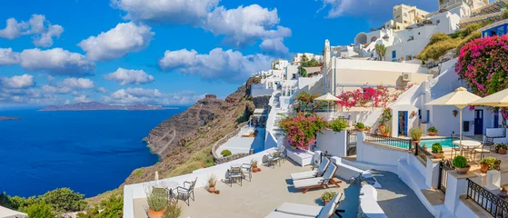 Rolgordijnen Amazing cityscape view of Santorini island, Oia village. Picturesque famous Greek resort Greece, Europe. Traveling concept background. Summer vacation, beautiful windmills and Aegean colorful building © icemanphotos