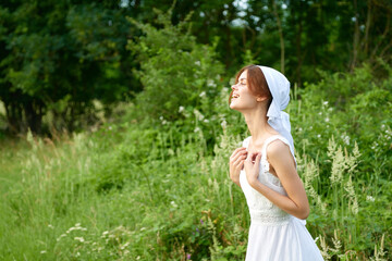 Fototapeta na wymiar Woman in white dress countryside plants nature