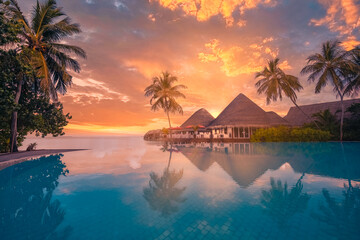 Sunset tourism landscape. Luxurious beach resort with swimming pool reflection beach chairs or...