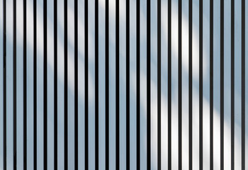 Obraz premium Soft shadows pattern is over white metal fence. Background texture