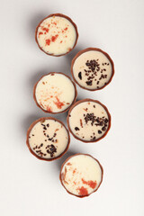 Flat lay composition with chocolate candies on white background