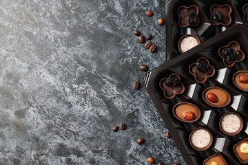 Concept of sweets with chocolate candies on dark textured background