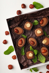 Concept of sweets with chocolate candies on white background