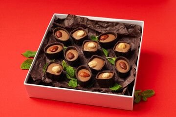 Concept of sweets with chocolate candies on red background