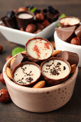 Concept of sweets with chocolate candies on wooden background