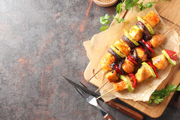 Concept of tasty food with chicken shashlik on dark textured background