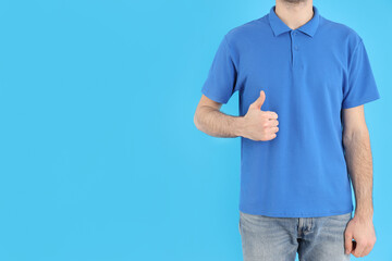 Man in blank blue polo on blue background