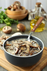 Concept of tasty food with mushroom sauce on gray wooden background