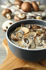 Concept of tasty food with mushroom sauce on gray wooden background