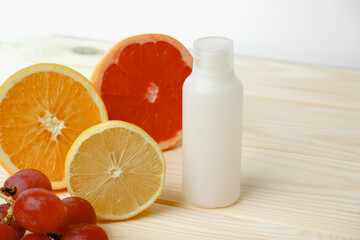Vitamins. White empty bottle for vitamins on a background of citrus fruit slices. lemon. orange. White background. Blank Medicine bottle