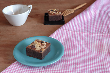 Fresh brownies in small dish on table. Delicious chocolate pie.