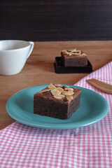 Fresh brownies in small dish on table. Delicious chocolate pie.