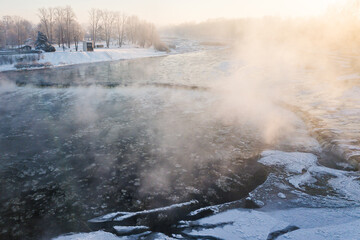 Aerial view of Venta river waterfall, the widest waterfall in Europe in foggy winter day, Kuldiga,...