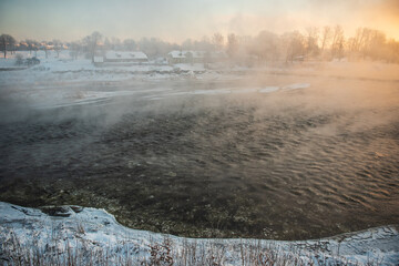 Foggy morning by the Venta river in winter, Kuldiga, Latvia