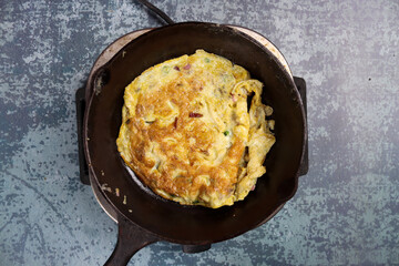 Egg omelet in a frying pan