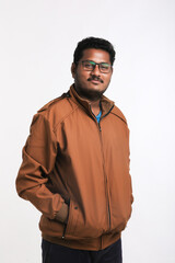 Young indian man wearing winter cloth or jacket on white background © PRASANNAPIX