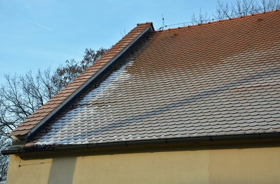 view of the roof made of red brick burnt tiles of the beaver type used in Central Europe on all historical roofs, especially in Austria. the bags overlap several times, they look like beaver teeth